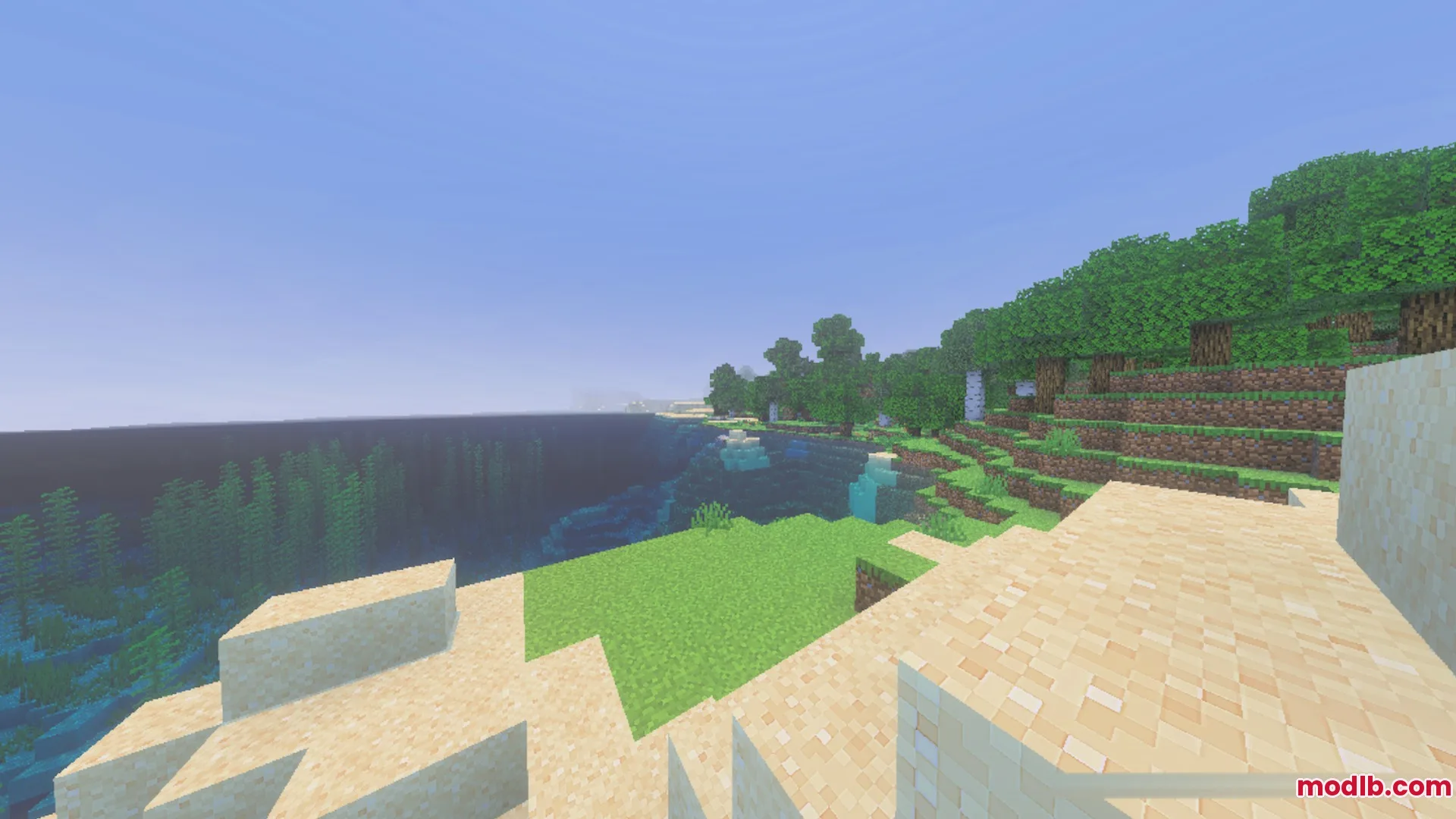 Swaying trees and grass overlook a clear ocean with underwater kelp plants