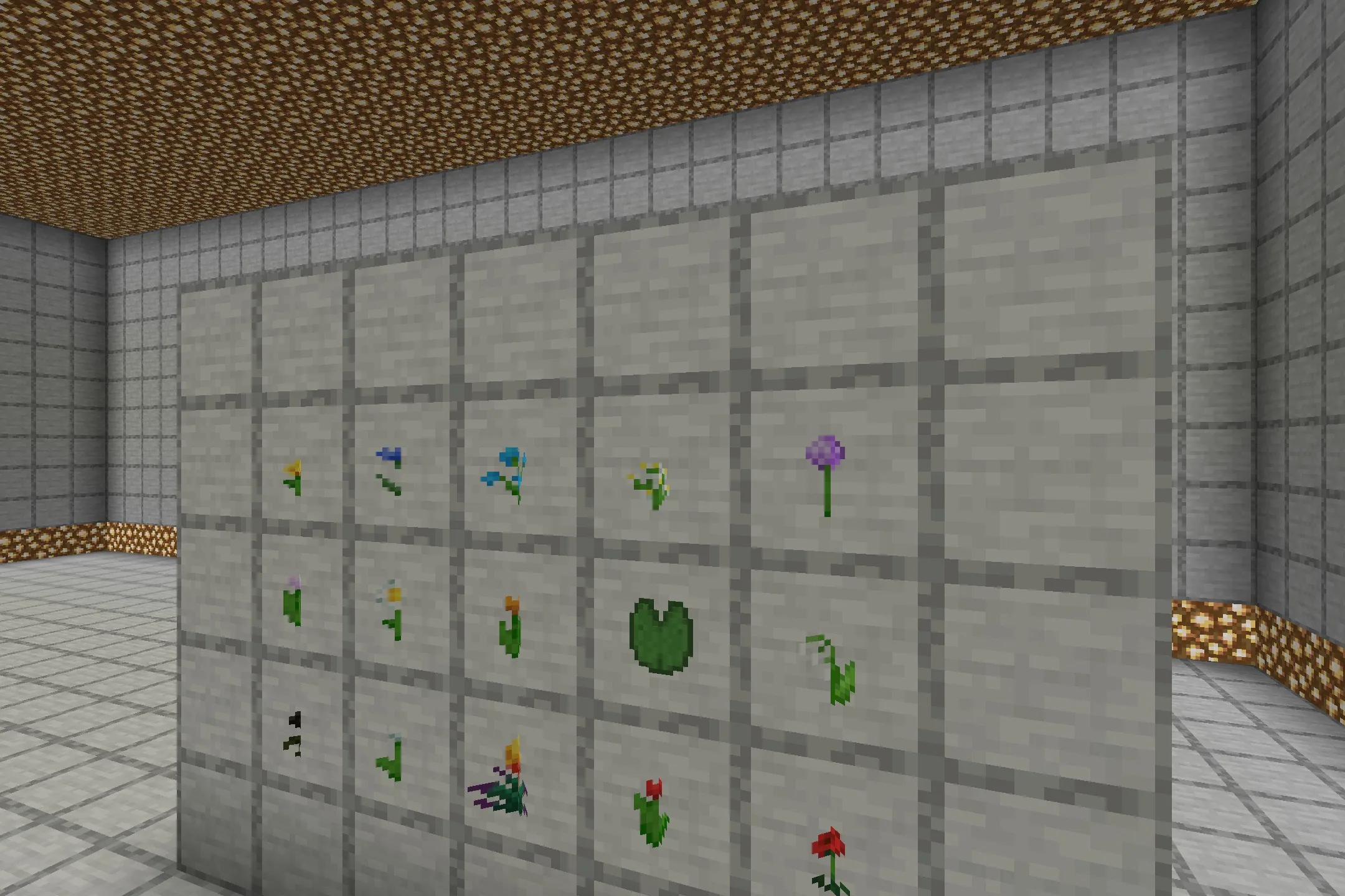 Various 3D flower models and lily pads displayed in item frames on stone