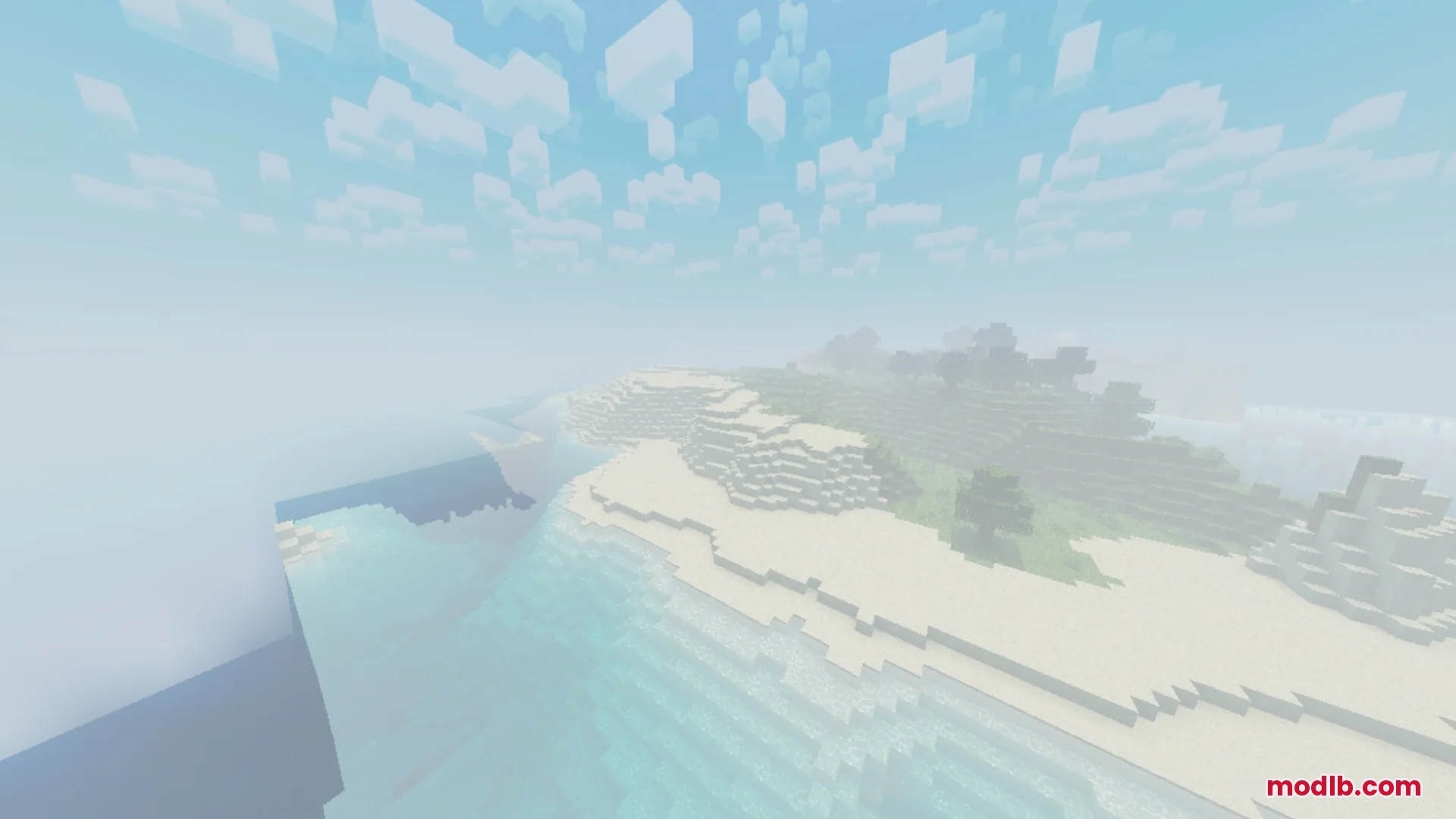 A scenic view of a foggy beach and ocean with soft lighting