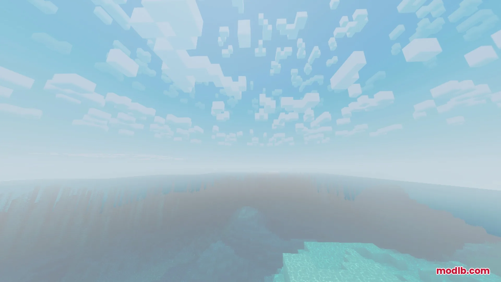 Blocky clouds drift across a bright sky above a misty ocean landscape