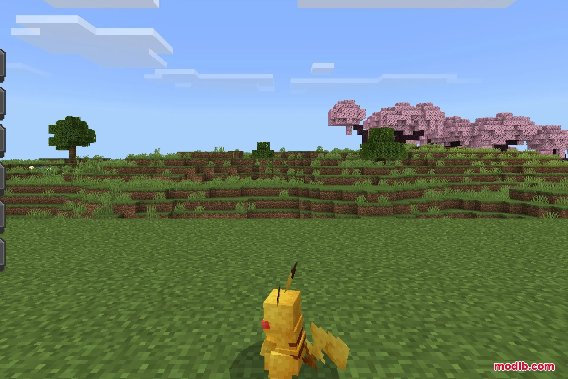 A yellow Pikachu mob stands in a grassy field with cherry blossom trees