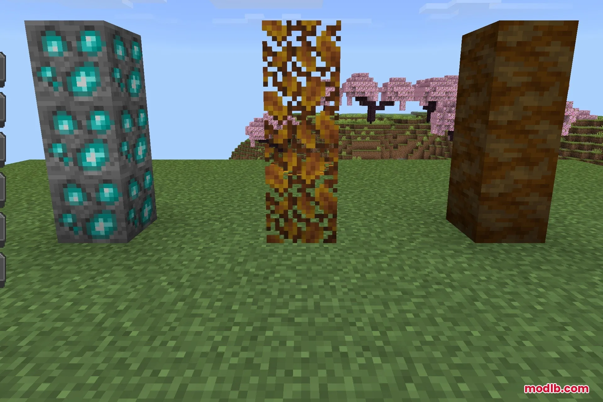 Custom blocks and ores displayed as vertical pillars in a grassy field