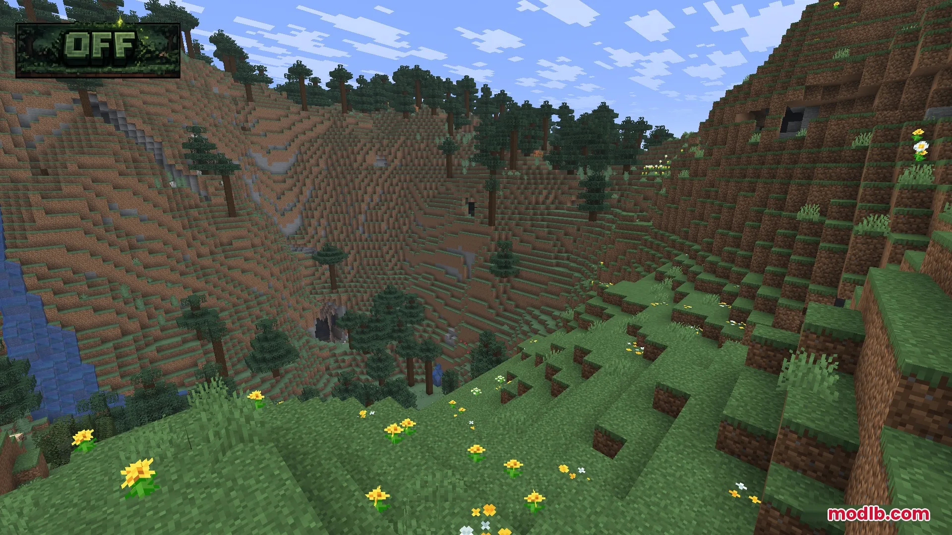 A scenic mountain valley with dark green grass and tall spruce trees