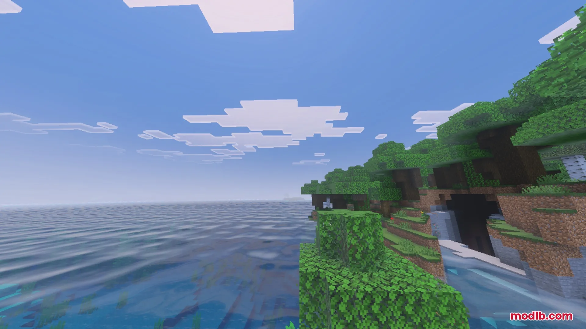 Lush green shoreline overlooking a vast sea with realistic dynamic water wave effects