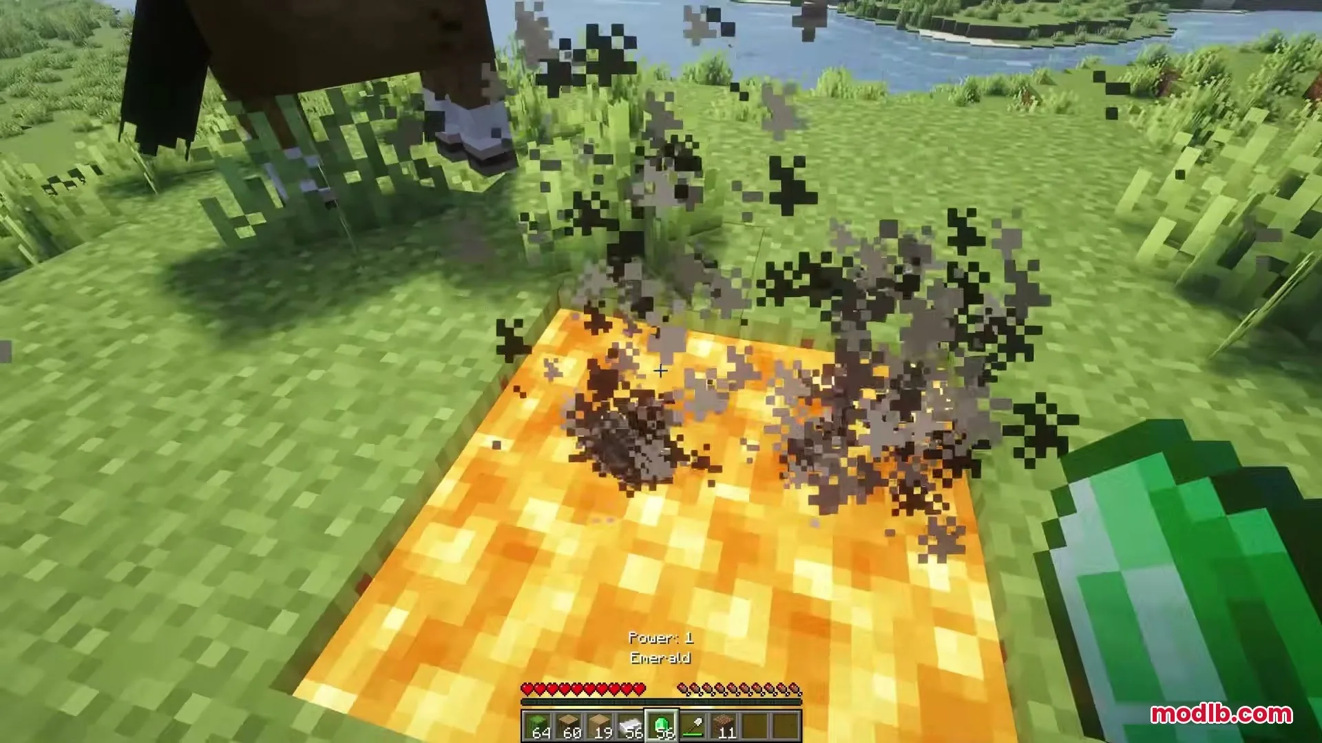 Eating Animations Mod Screenshot 9 Player holding an emerald item near a glowing orange block with smoke particles