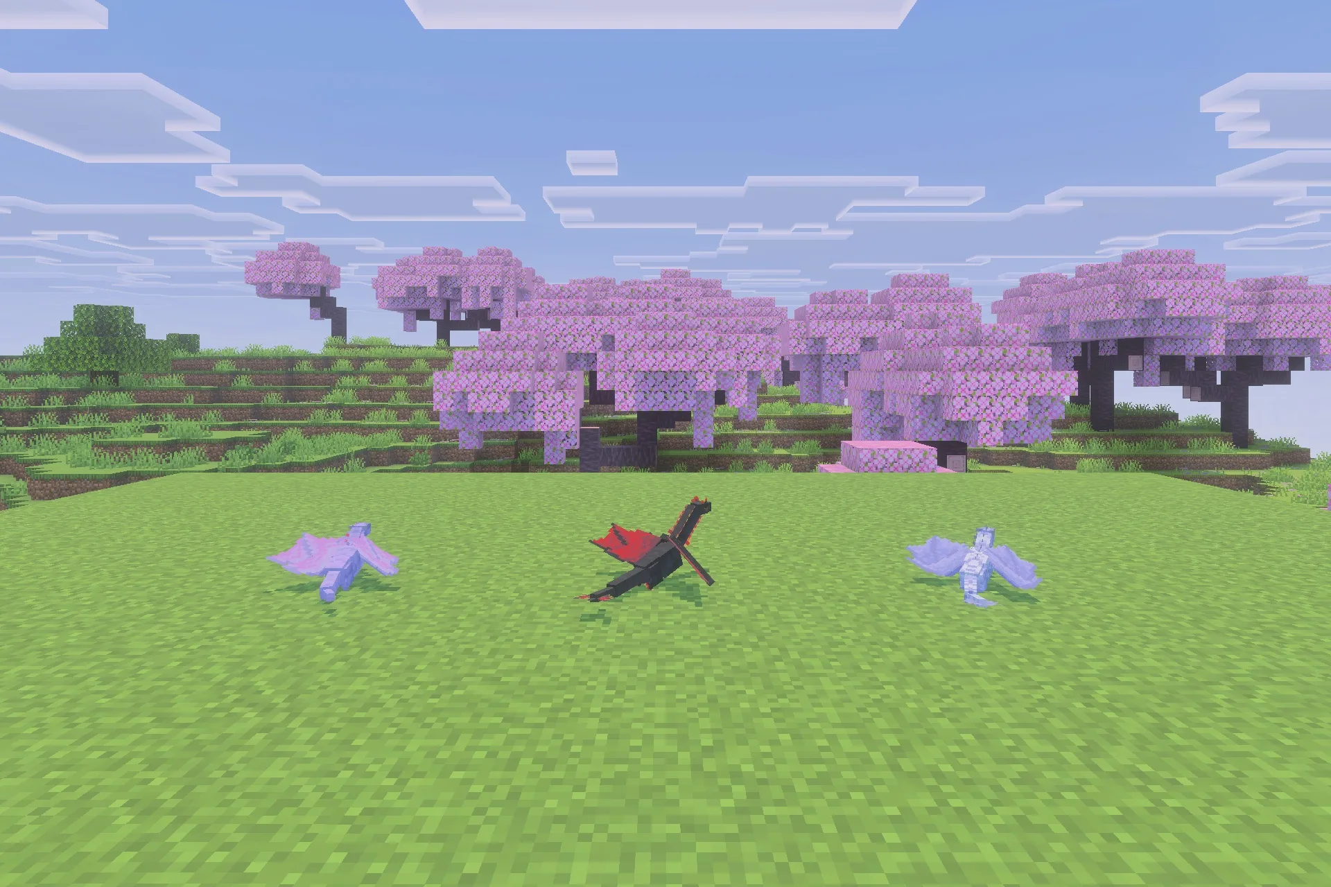 Three baby dragons standing on green grass near pink cherry blossom trees