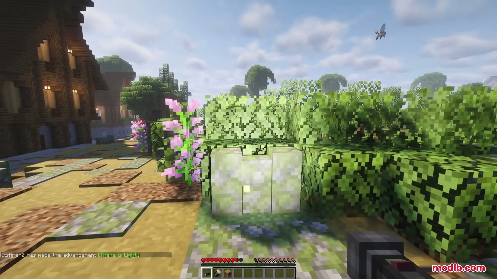 Flashier Flashlights Mod Screenshot 1 Player holding a flashlight item in a garden during a sunny day