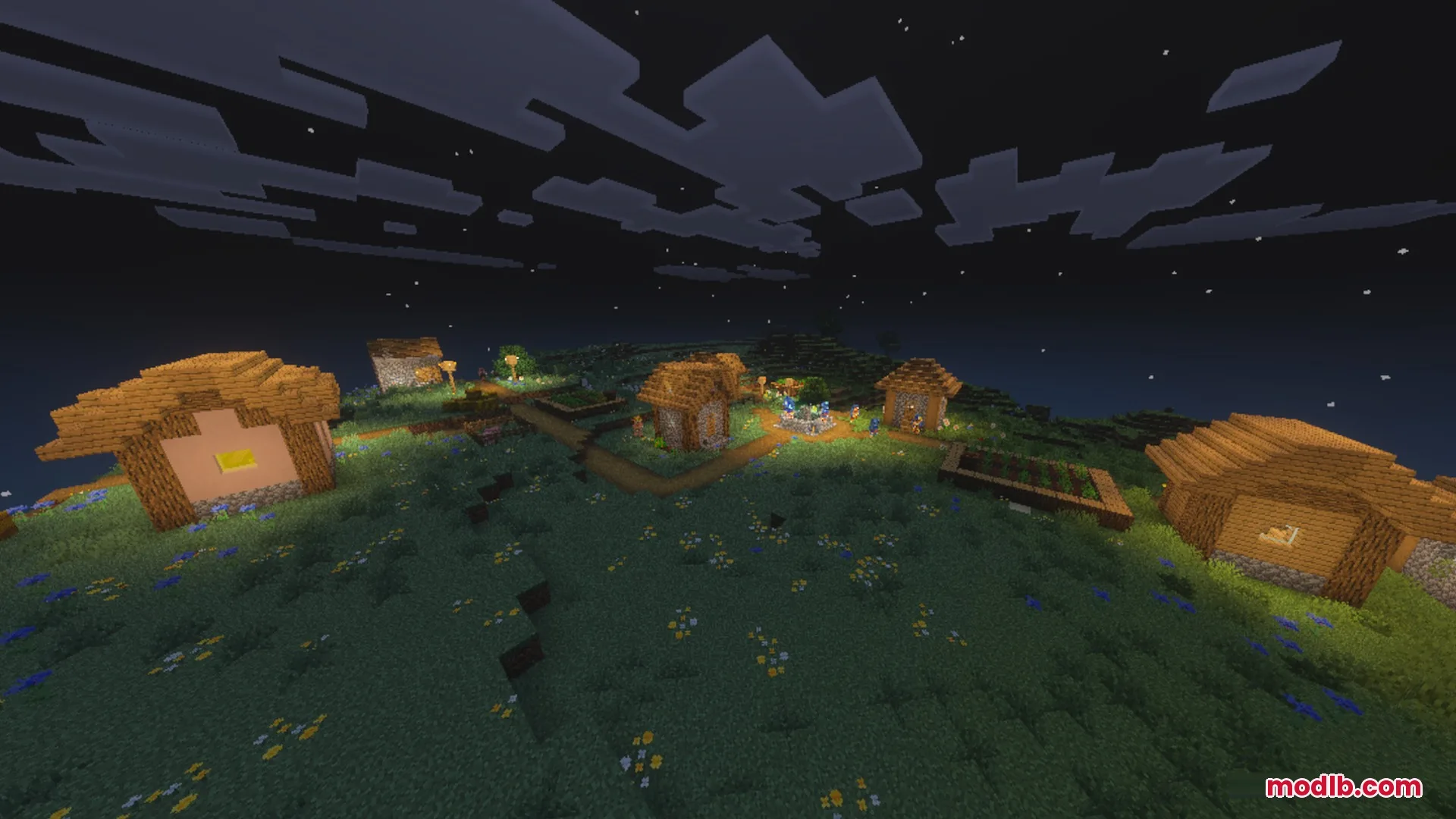 A small Minecraft village illuminated by warm lanterns during a clear starry night
