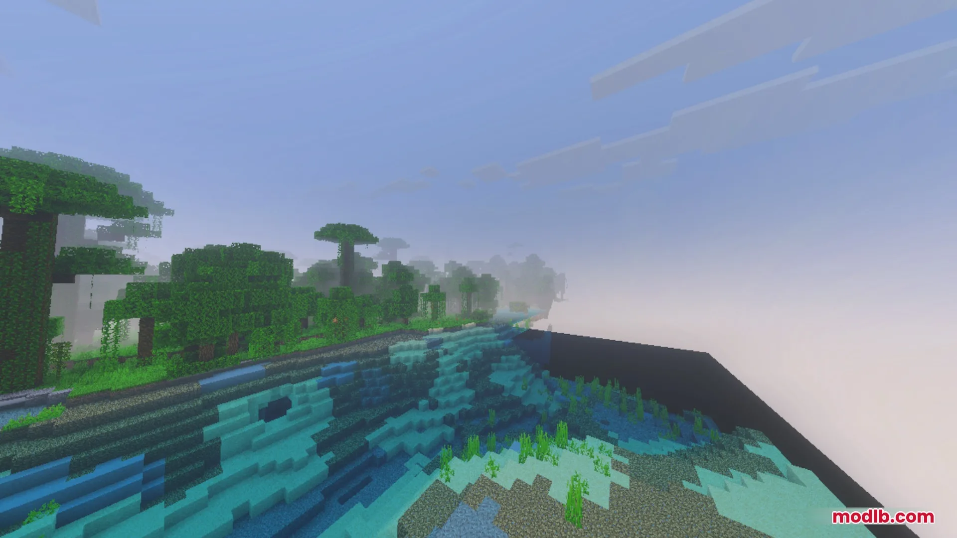 A hazy jungle landscape next to a blue ocean with green seagrass visible