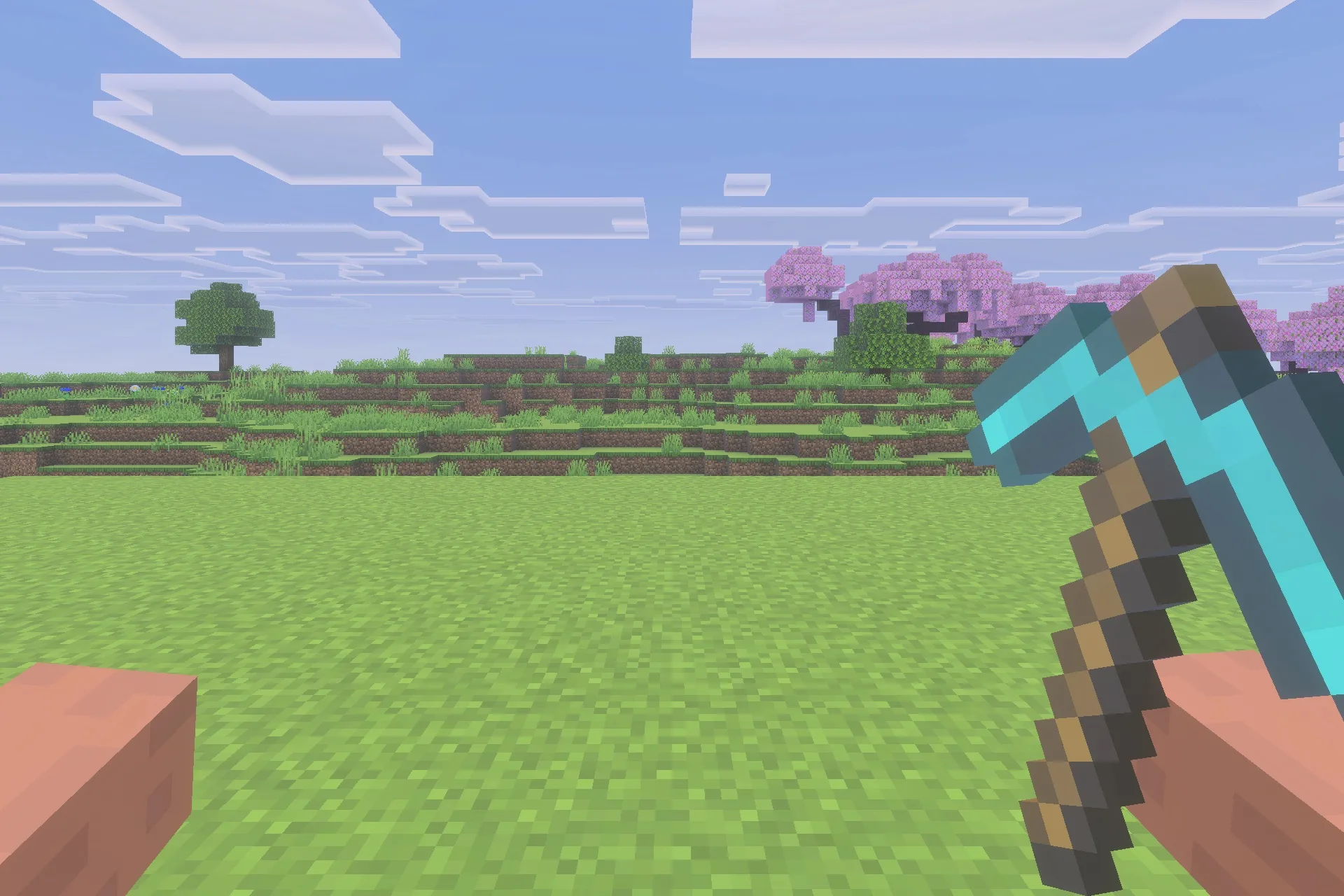 A player holding a diamond pickaxe while looking at a cherry blossom forest