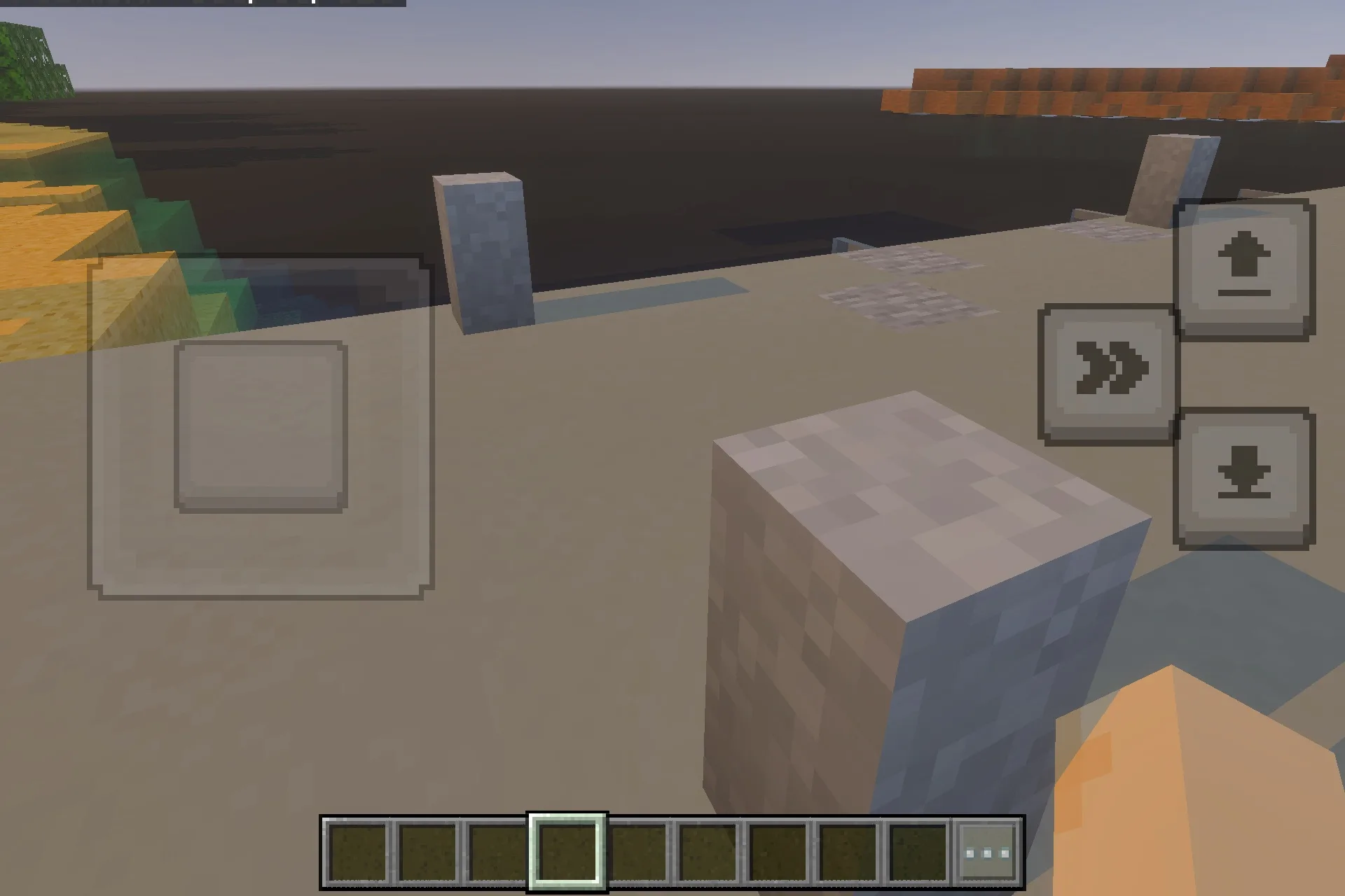 Stone blocks placed along a shoreline overlooking a vast body of water