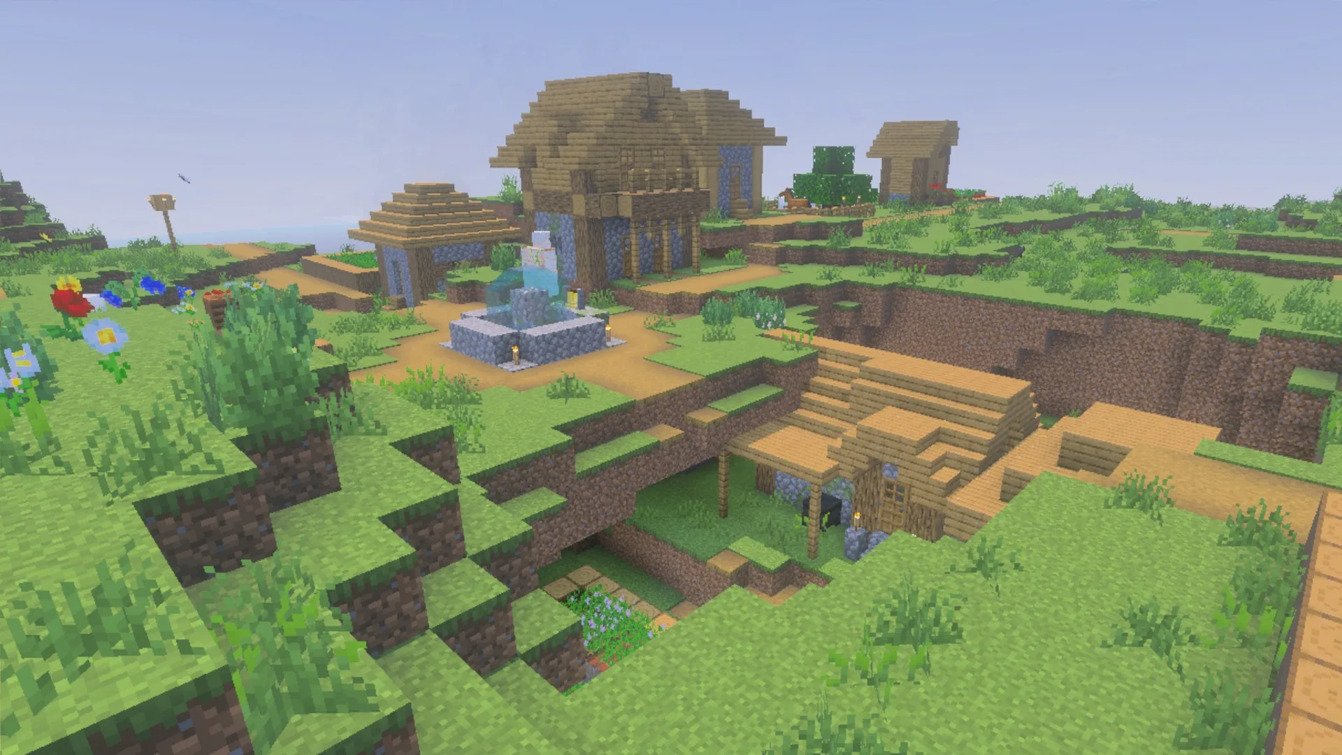 Village buildings and a fountain in daylight showing the La Nature block textures