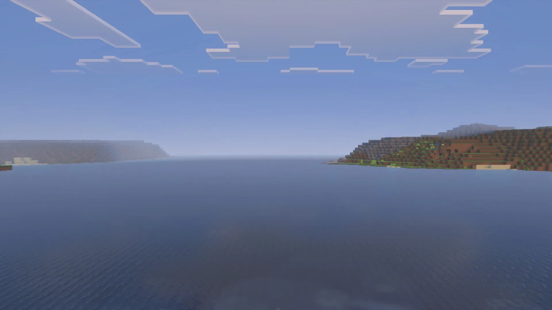 Daytime ocean water, clouds and shoreline with the La Nature pack