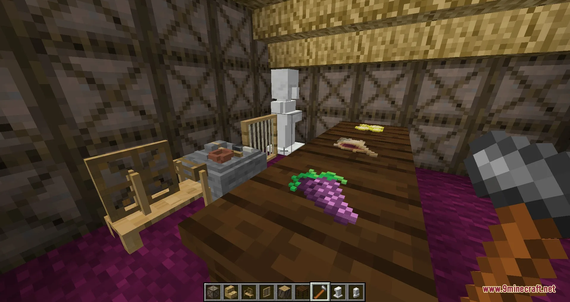 Player holding a hammer in a room with food and a statue