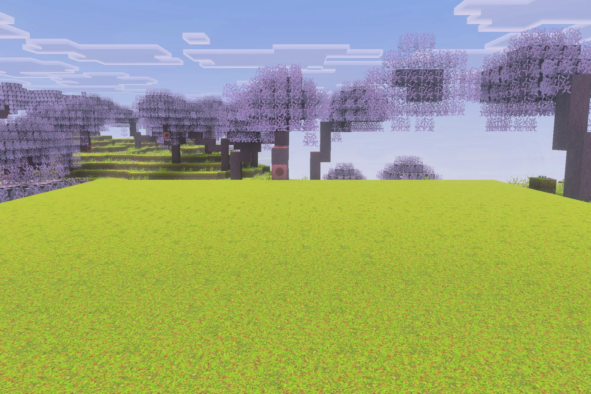 Optimum Realism for Bedrock Edition Texture Pack Screenshot 1 A scenic view of cherry blossom trees and a vast green field