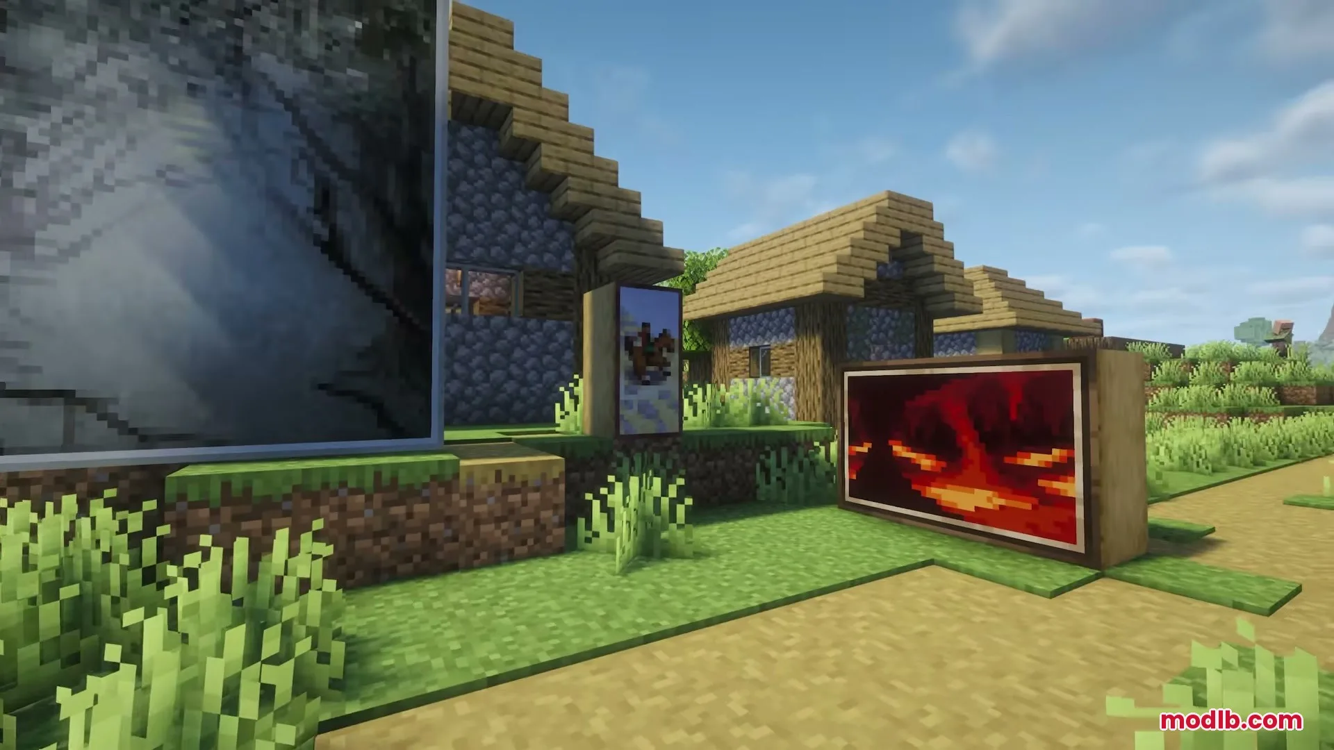 Several unique paintings displayed outside a village house in a Minecraft world
