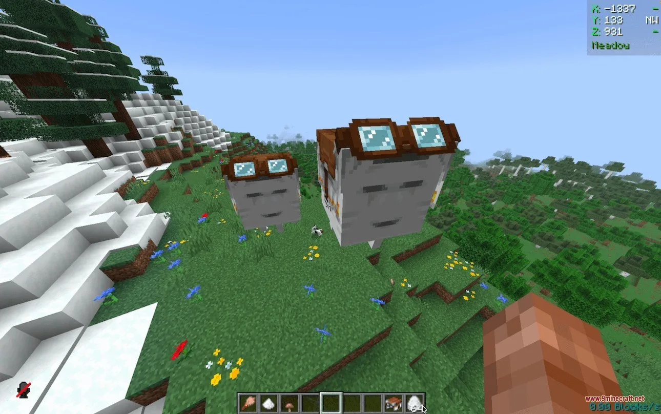 Two small Ghasts wearing goggles float together on a green grassy hill