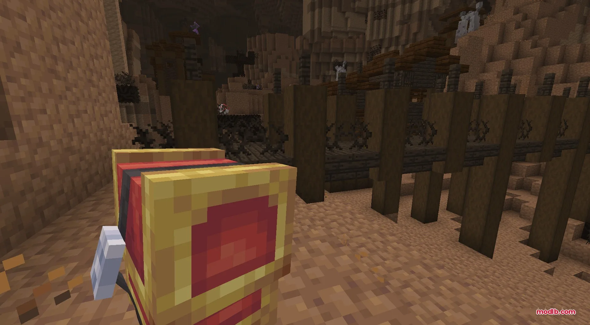 A player explores a deep underground cave while holding a red Cherish Ball