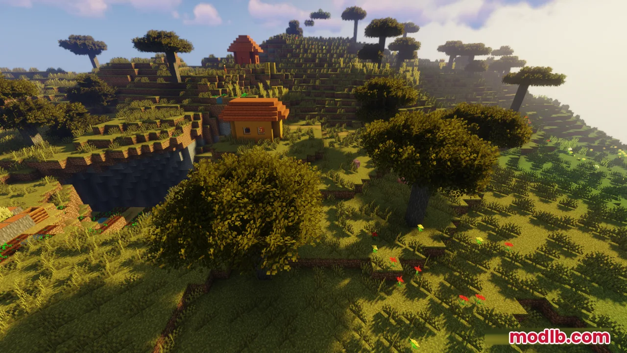 Bushy trees and small houses on a hill during a warm sunset