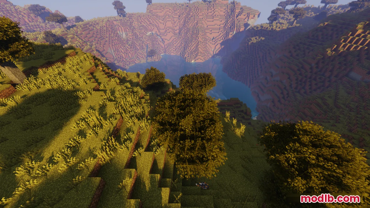 Looking down from a cliff at bushy trees and a flowing river