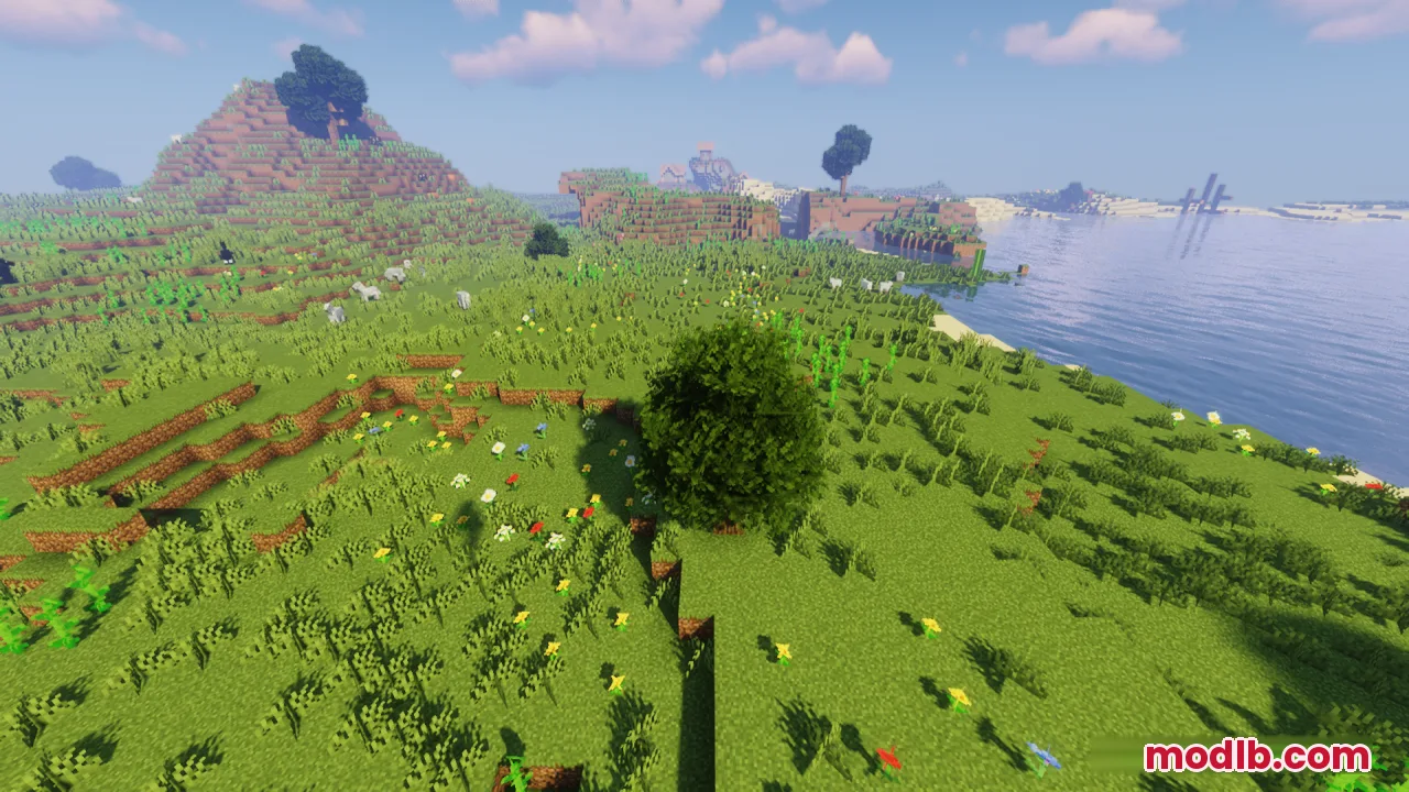A large bushy tree stands in a green Minecraft field next to a lake
