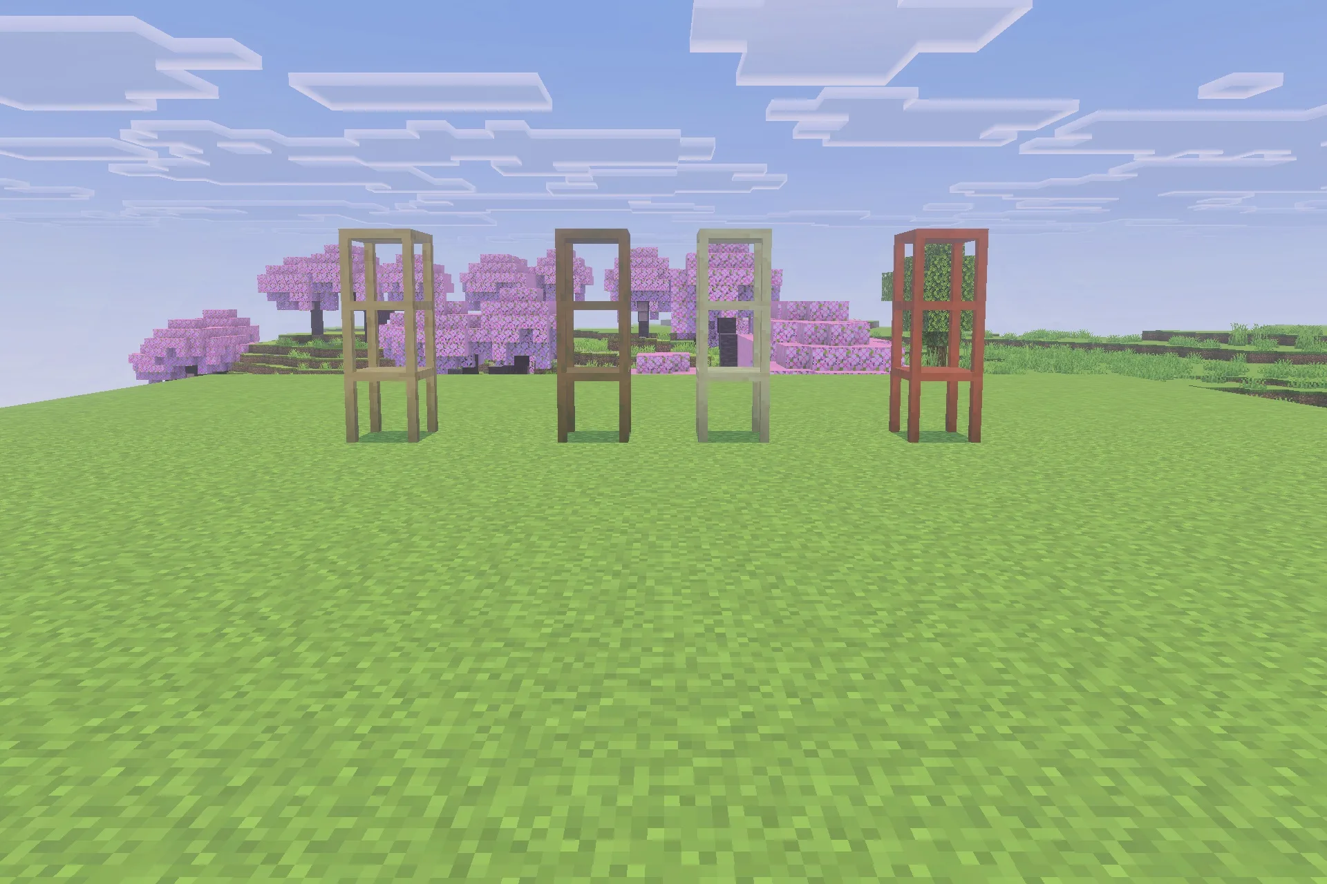 Four wooden storage shelves standing in a field with cherry blossom trees