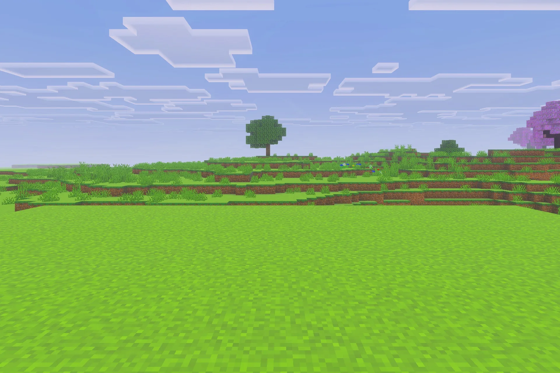 Saturated for Bedrock Edition Texture Pack Screenshot 3 Vibrant green landscape with a single tree under a bright blue sky