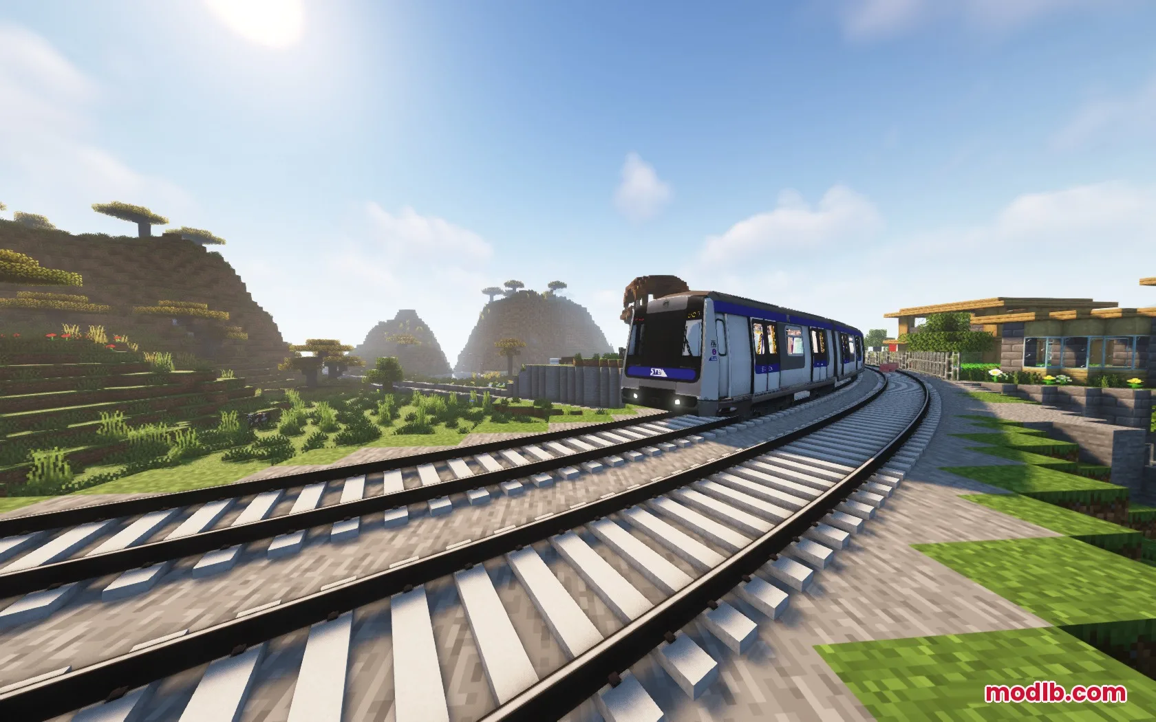 A blue and white train traveling on curved tracks through a Minecraft savanna