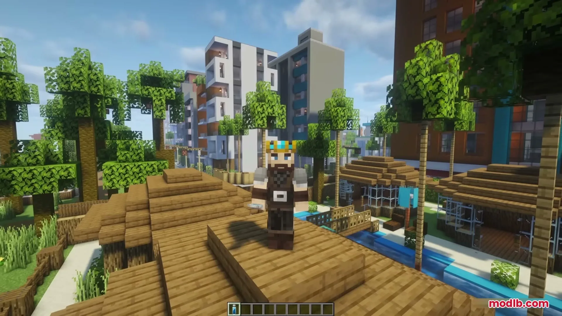 Crowned character stands on a wooden roof overlooking a modern Minecraft city