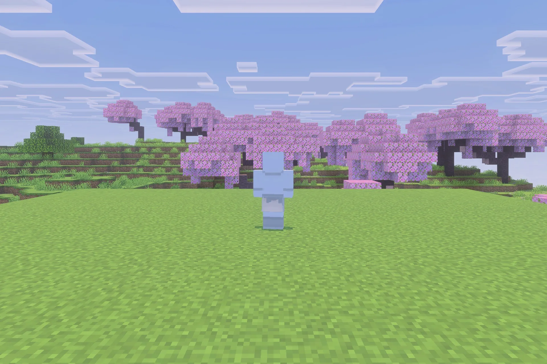 A transparent blue humanoid figure stands in a field of cherry blossom trees
