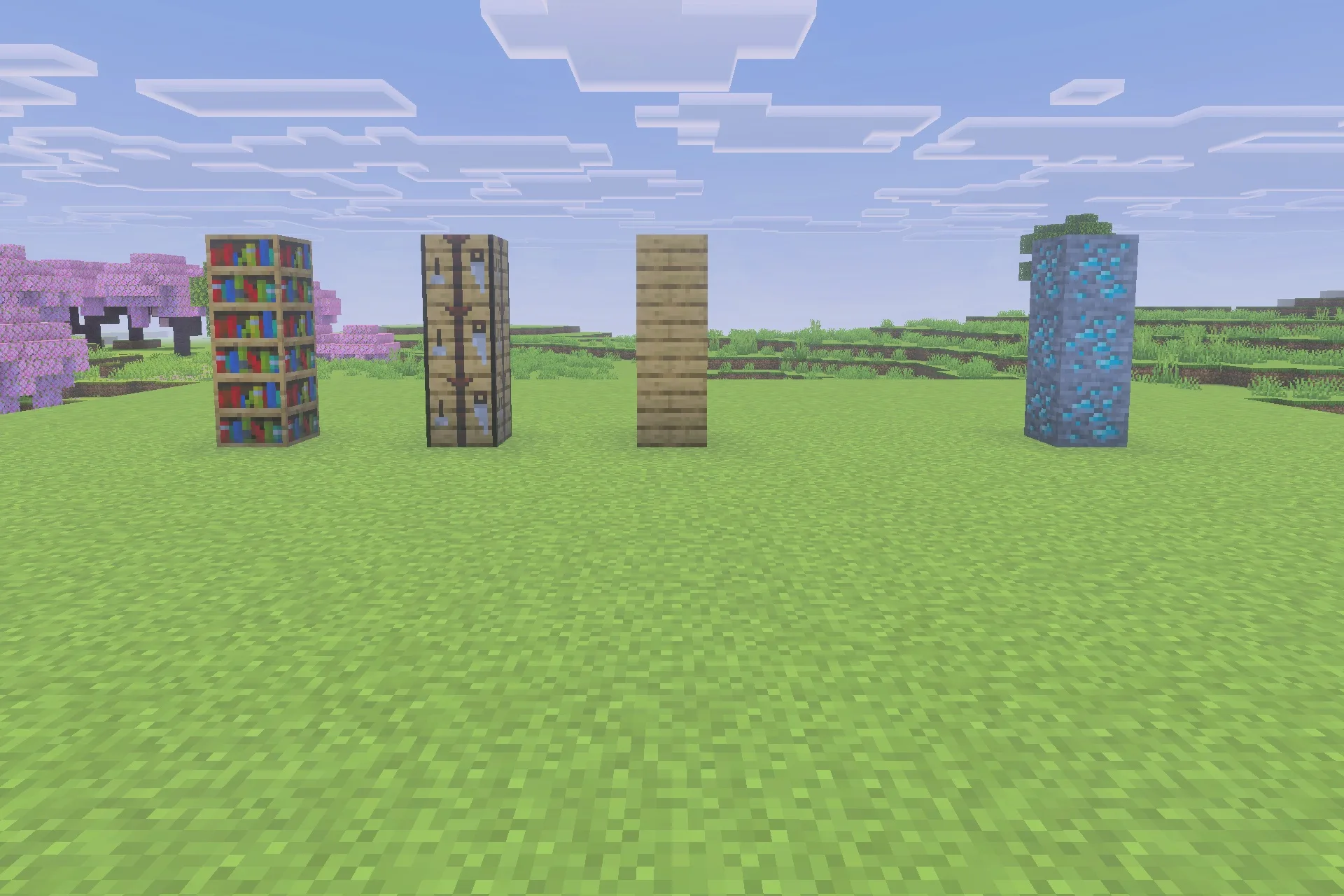 Four pillars of detailed 3D Minecraft blocks standing on a grassy field