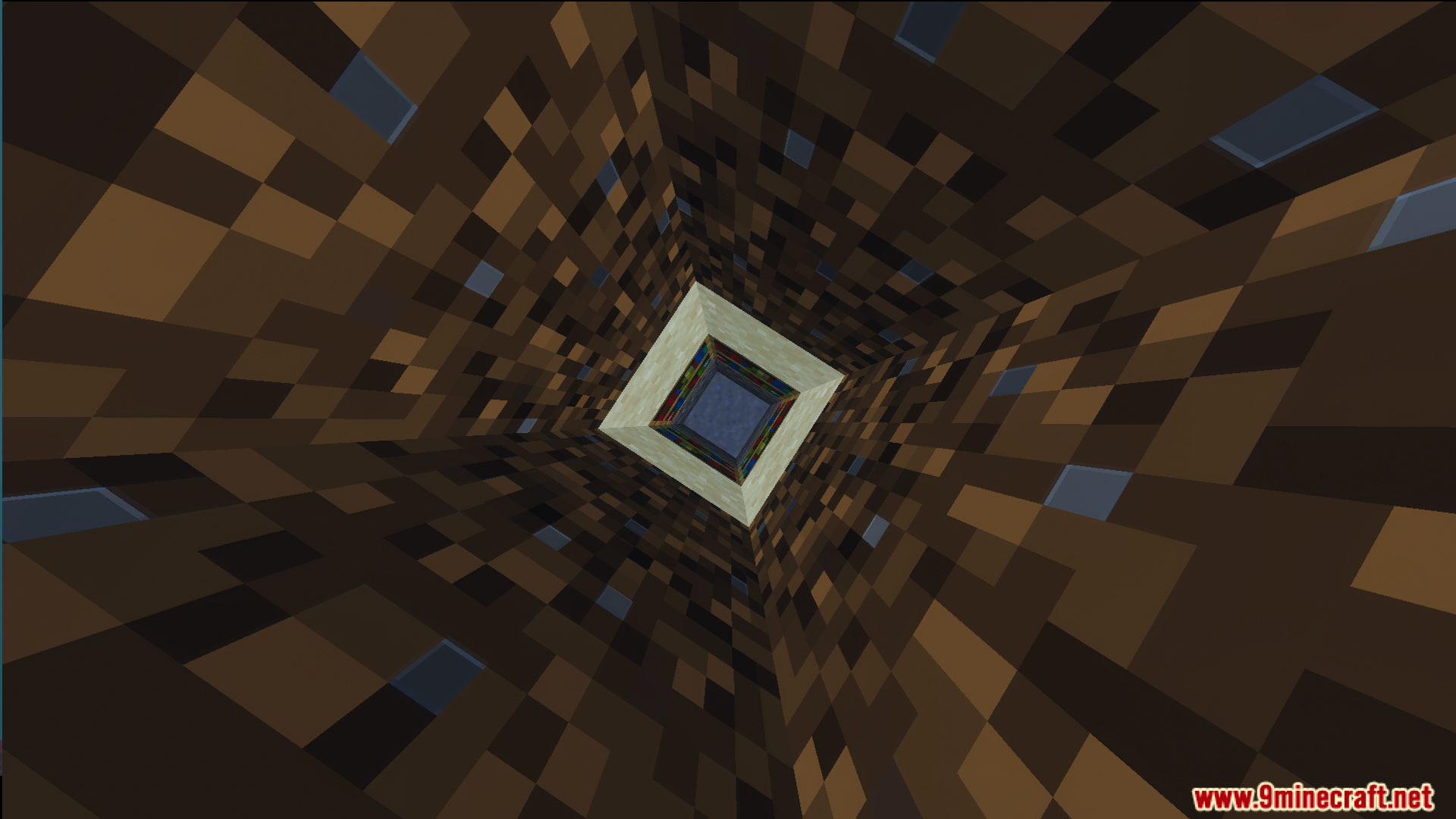 Looking down a deep square hole through many layers of brown dirt blocks