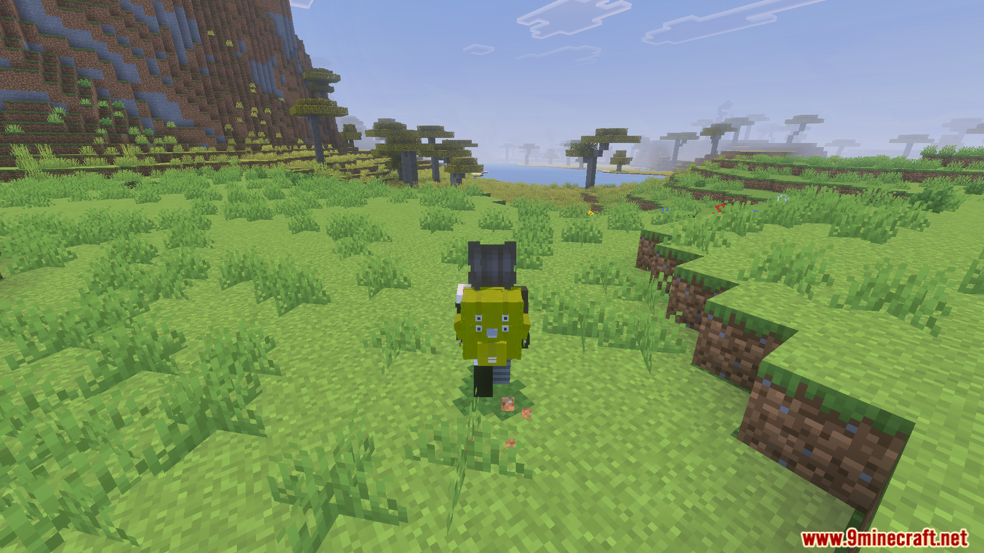 Actual Backpack Addon Screenshot 7 Player wearing a yellow Actual Backpack Addon item while exploring a savanna