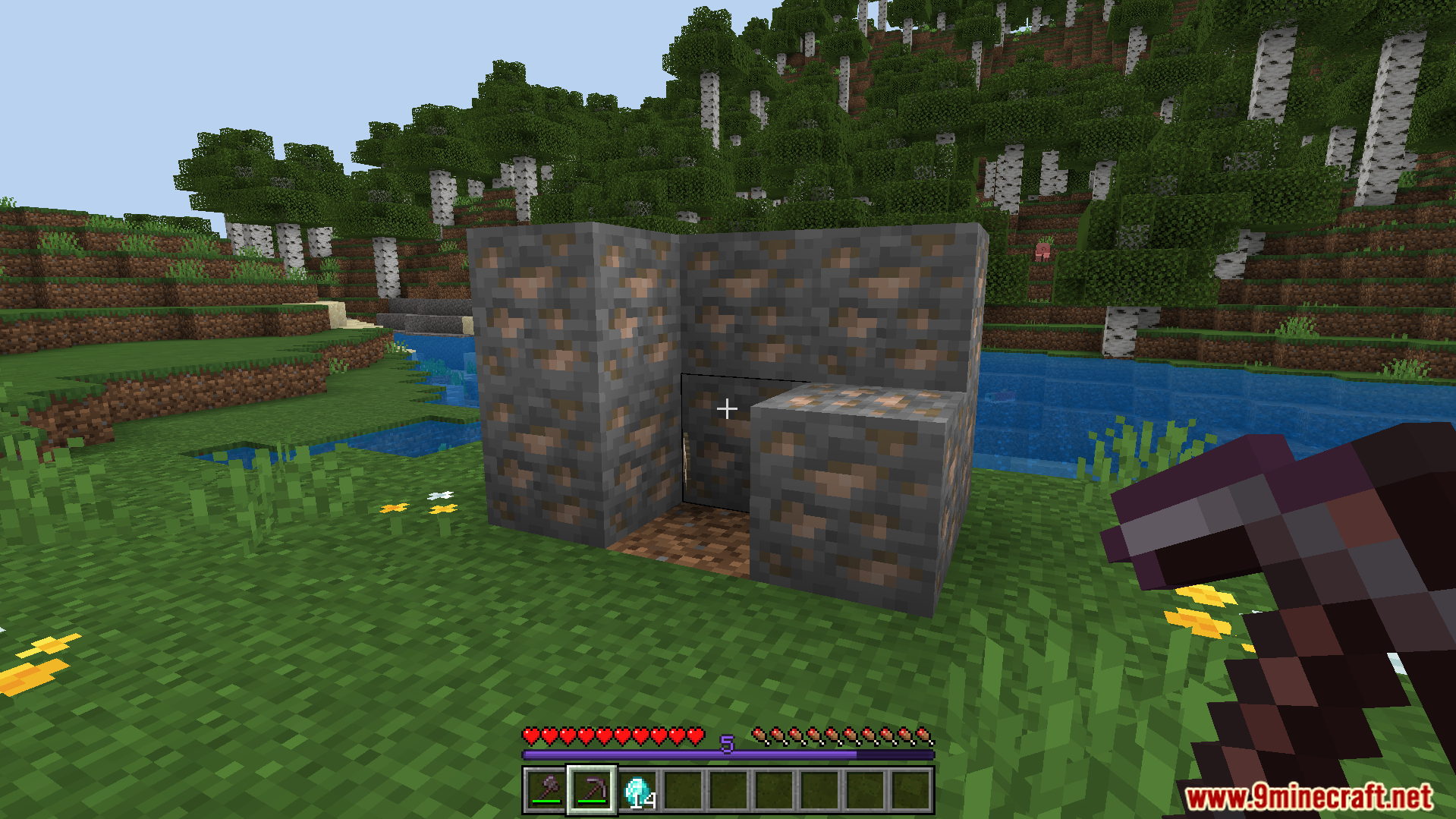 Player preparing to mine a cluster of iron ore blocks with a pickaxe