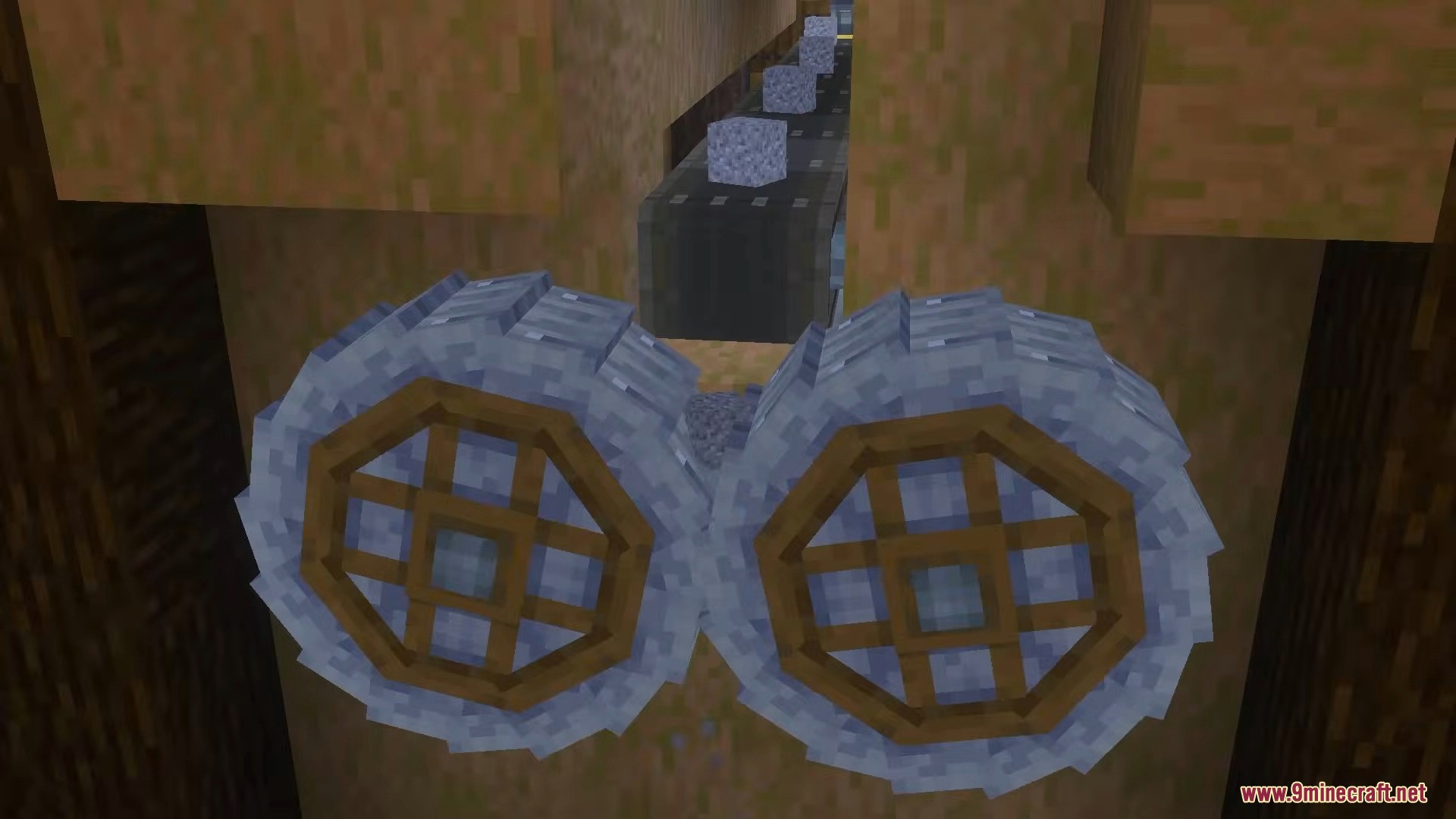 Create Bedrock Addon Screenshot 14 Two large crushing wheels processing cobblestone dropped from a mechanical belt above