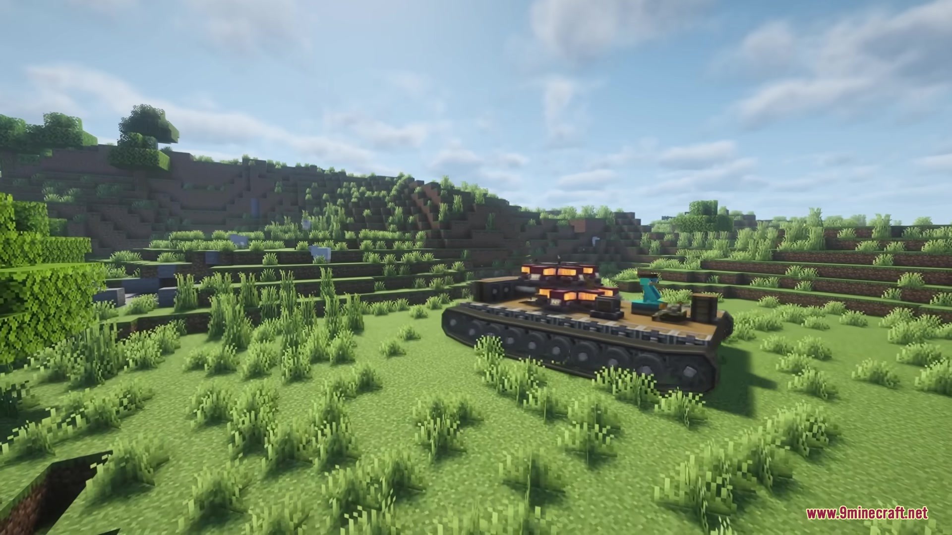 Create Tracks Mod Screenshot 2 A heavy vehicle with functional tank tracks drives across a grassy hill
