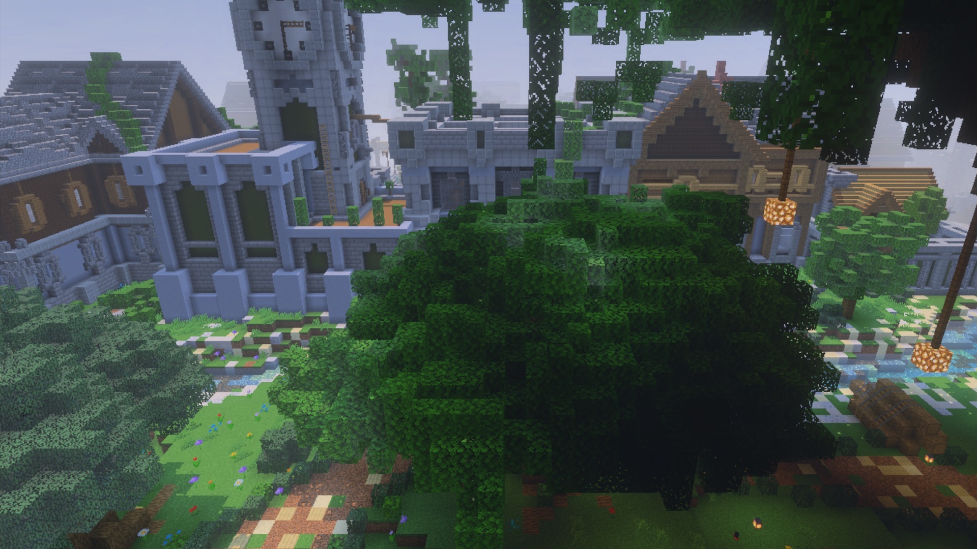 A scenic view of a Minecraft village with a large green tree