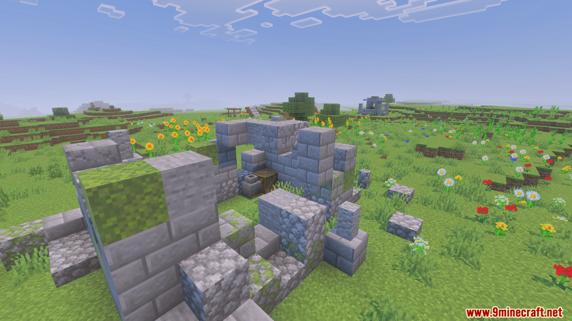 Small stone ruin structure found in a grassy field with colorful flowers