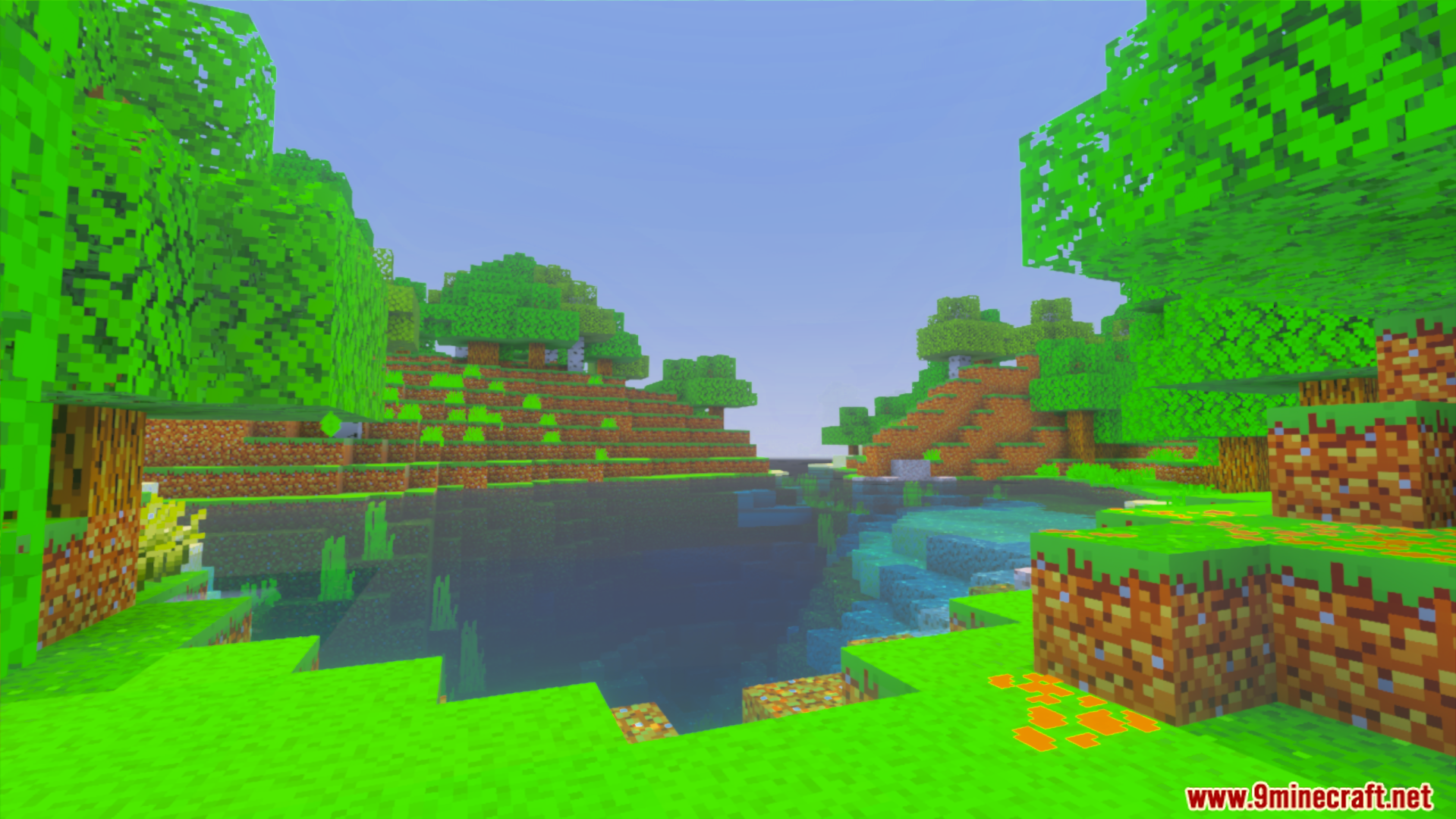 Lush green landscape with trees and a small pond