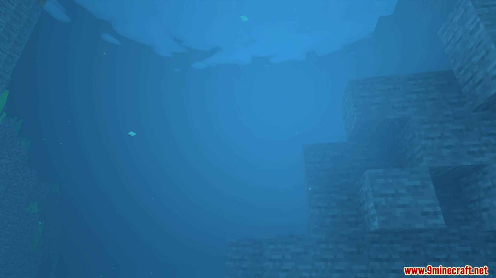 Underwater view showing blue water and stone blocks on the seabed