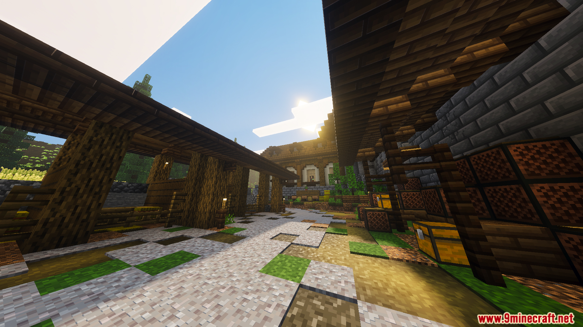 A path through a medieval settlement with wooden structures and stone houses