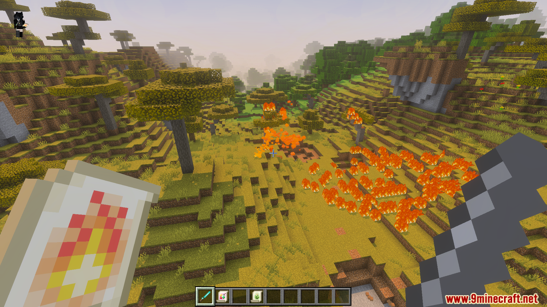 Player holding a fire scroll while standing in a burning savanna biome