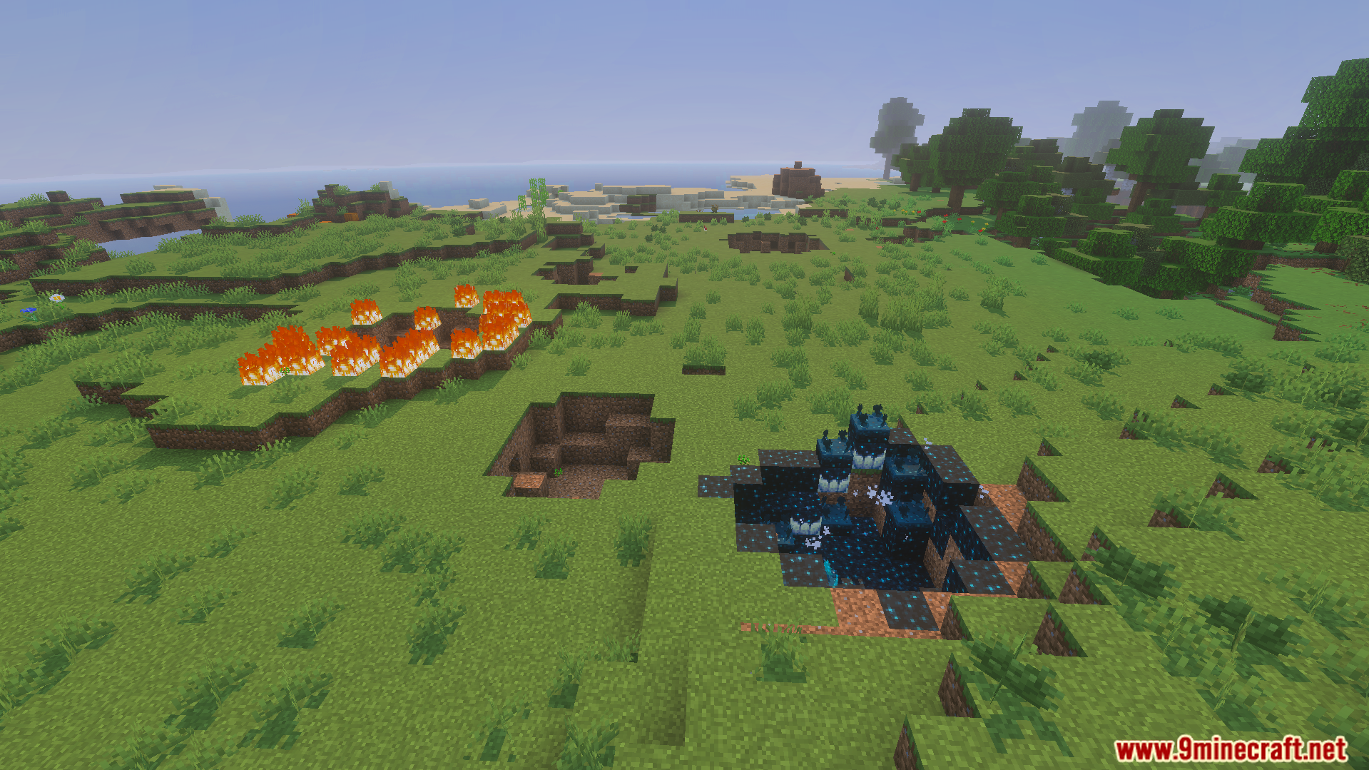 Crater with sculk blocks and fire in grassy landscape
