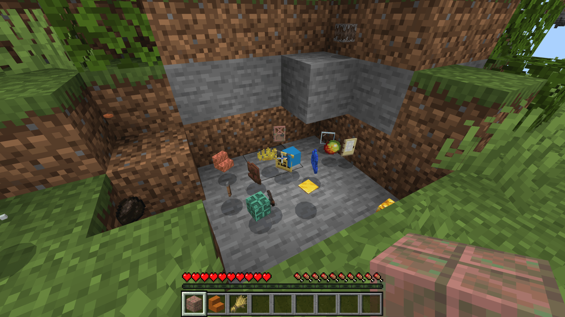 Various random items scattered on the ground in a dug area