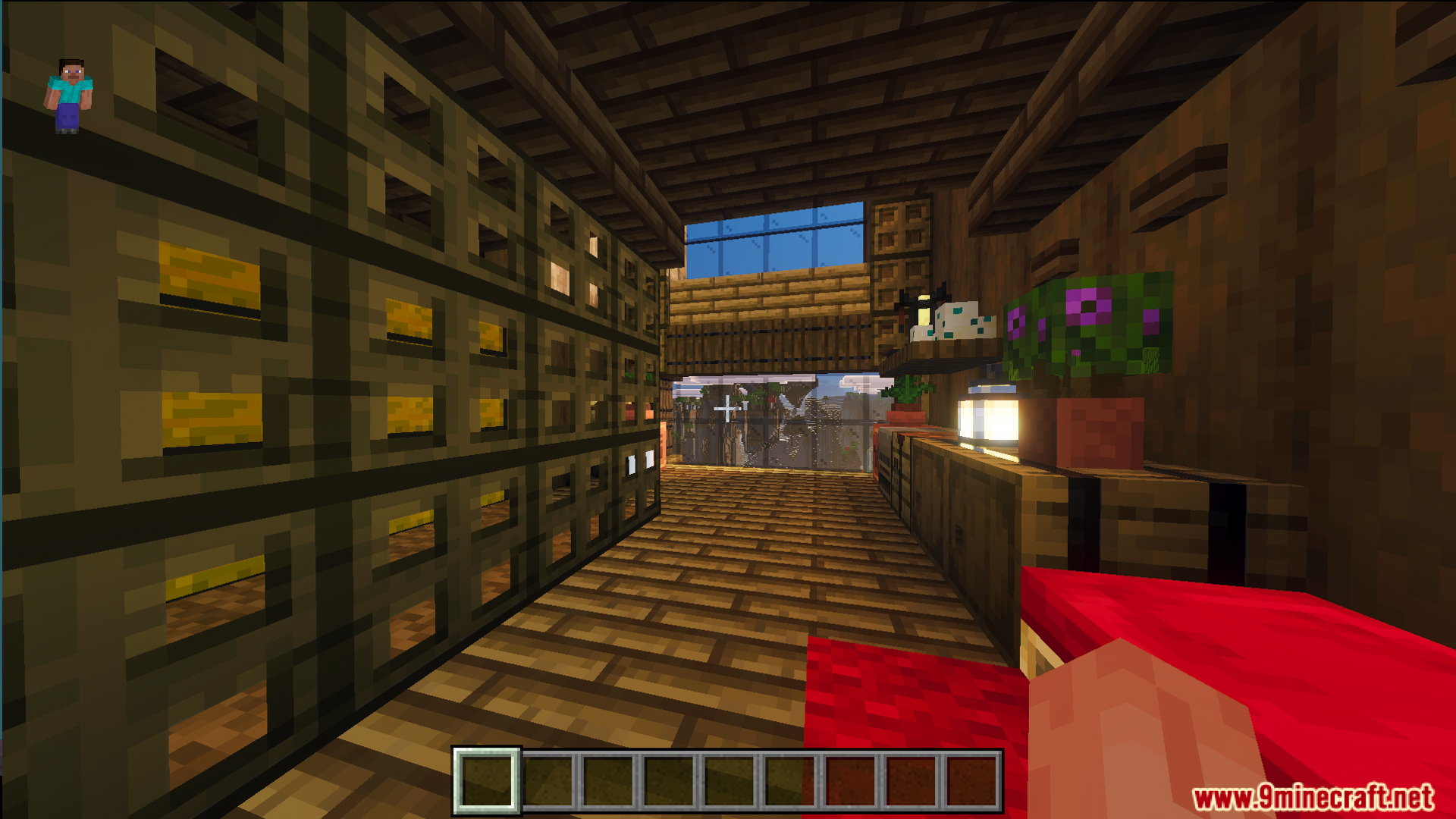 Cozy room with storage chests a red bed and large glass windows