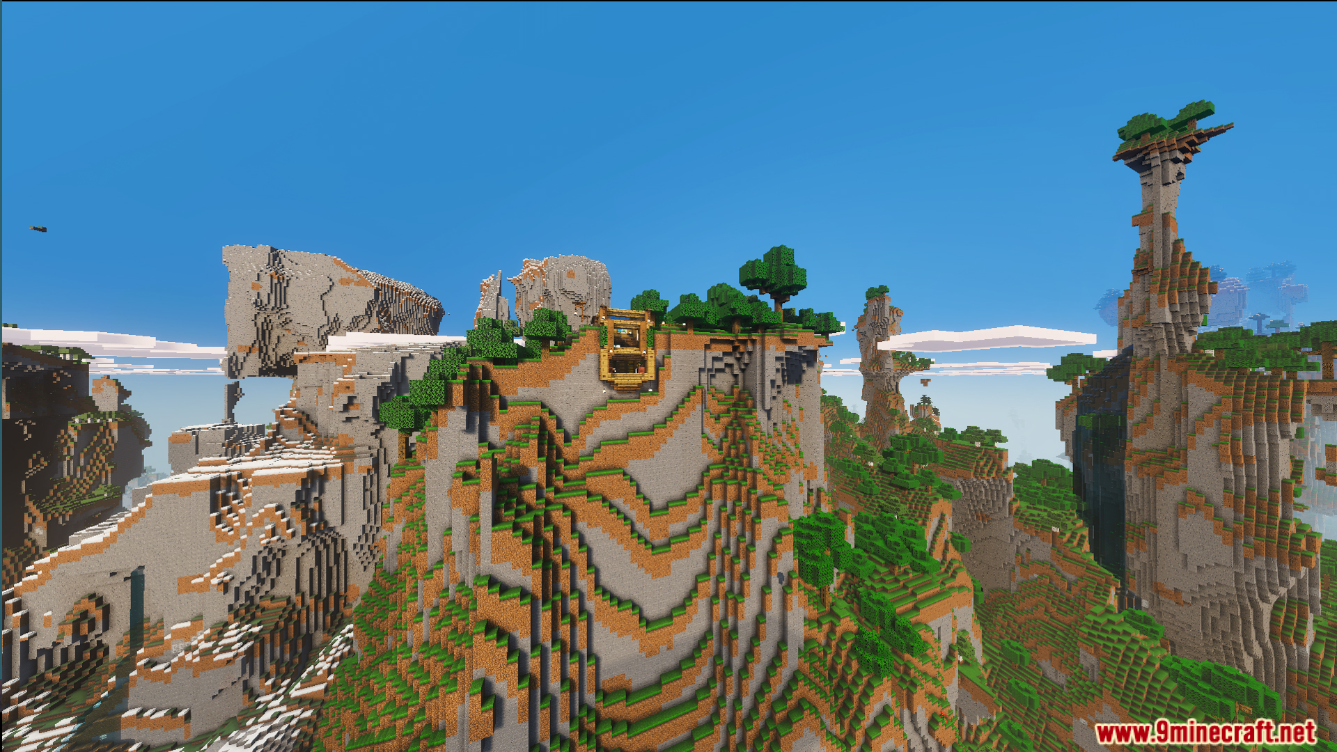 Scenic mountain landscape showing the cliff house and high peaks under blue sky