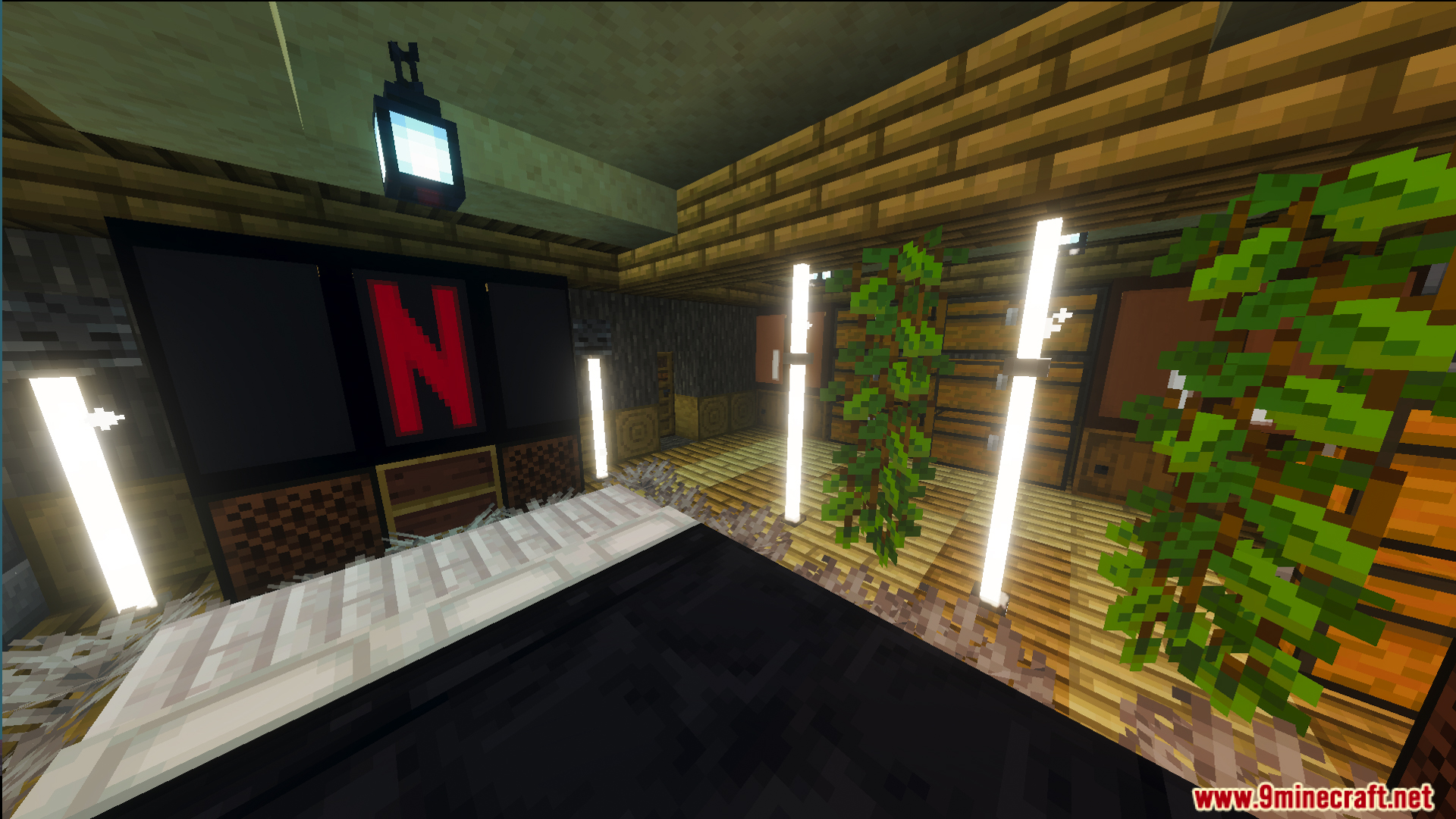 Cozy interior room featuring a large screen and decorative indoor plants
