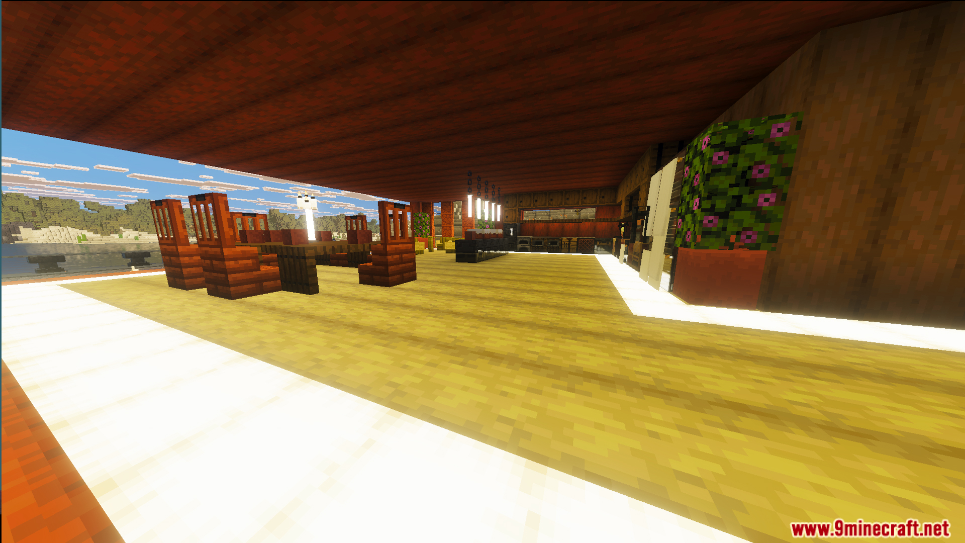 Spacious interior area with wooden dining furniture and large windows overlooking the landscape