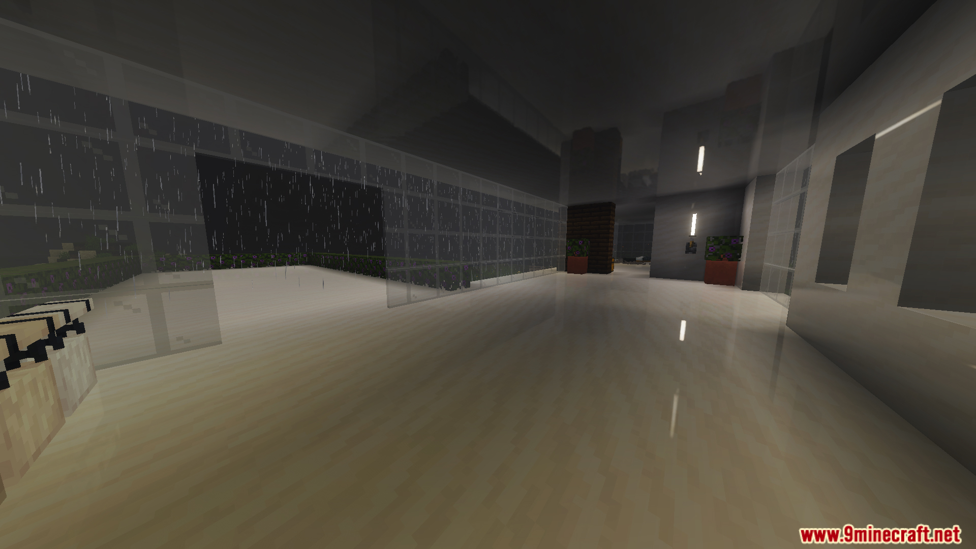 Interior view of a modern house featuring white floors and large glass windows