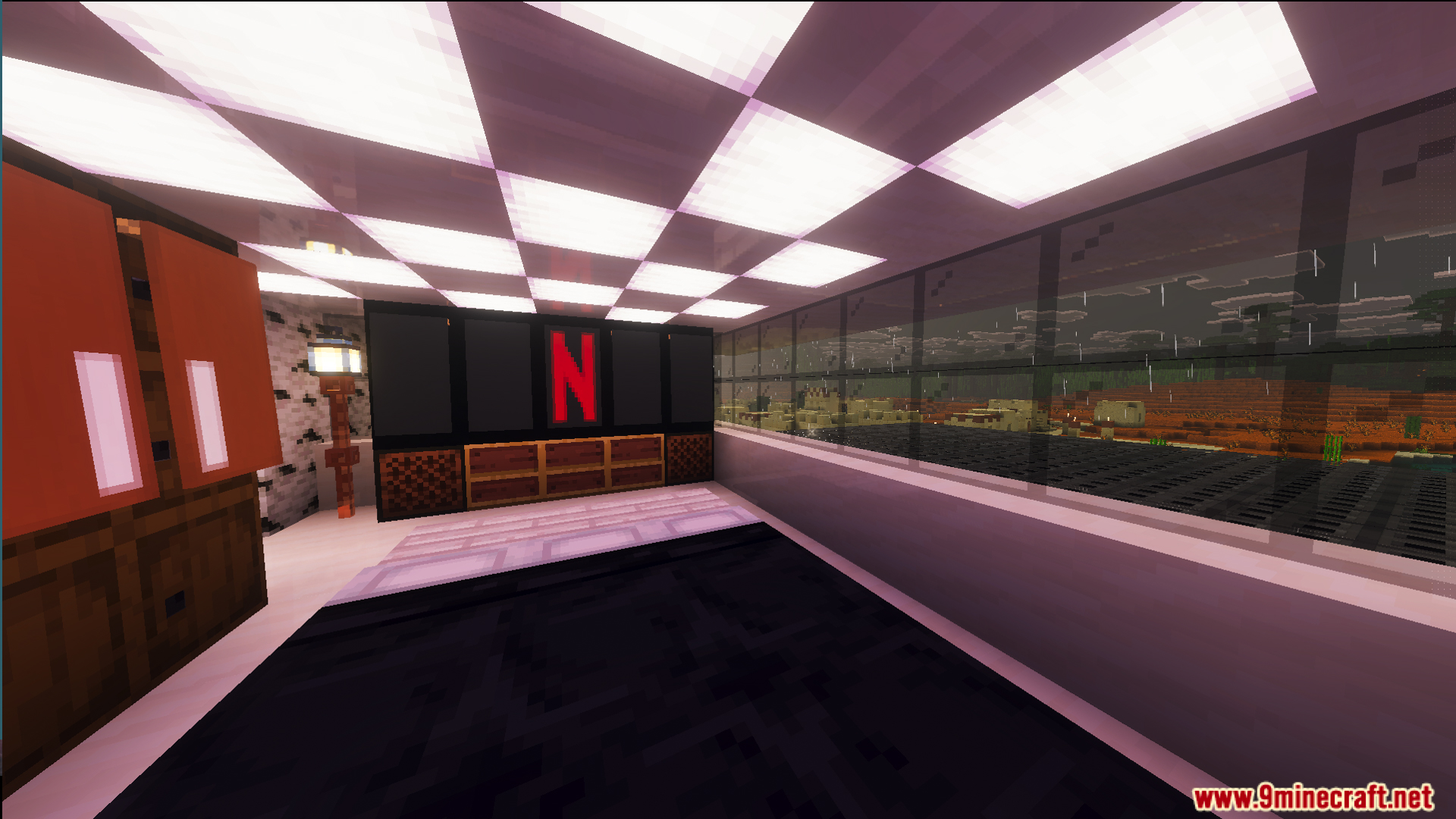 Modern bedroom with a large black television overlooking a rainy desert biome
